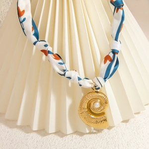 Nautilus shell pendant necklace in 18K gold with pearl inlay and floral silk scarf strap