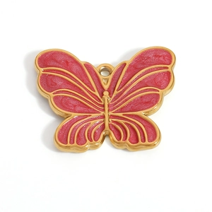 Detailed macro view of a butterfly pendant with pink enamel and a gold-tone metallic frame