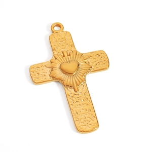 Detailed macro view of 18K gold plated cross pendant with hammered texture and heart center