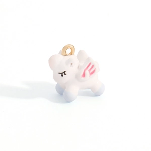 Close-up of a cute unicorn pendant charm with colorful enamel wings and a gold hanging loop