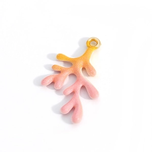 Macro detail of coral branch alloy pendant in pink orange gradient with glitter finish
