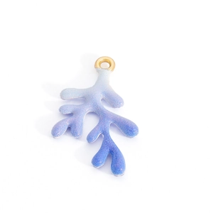 Macro detail of a gradient blue and purple coral branch pendant with pearlescent glitter