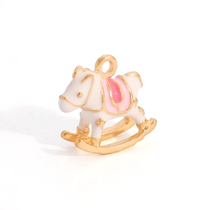 Macro shot of a cute white rocking horse alloy pendant with pink enamel and gold details