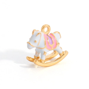 Macro shot of a cute rocking horse charm pendant with colorful enamel and gold finish