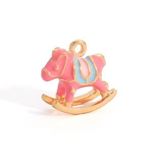 Macro shot of a pink and blue enamel rocking horse pendant with gold-plated metal finish