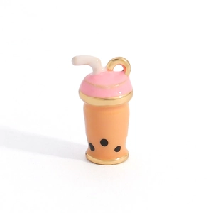 Macro detail of a cute boba milk tea charm pendant with pink lid and golden ring