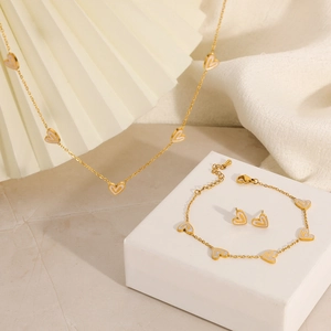 Macro detail of 18K gold plated stainless steel heart necklace and bracelet set