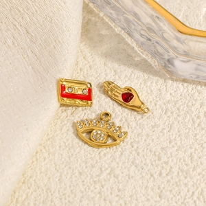 Three-piece 14K gold plated jewelry charms set with evil eye, palm heart, and retro tape shape
