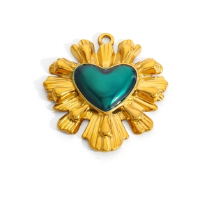 Golden heart pendant with sunburst sunbeam edges and a deep green resin core charm