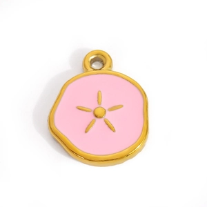 Macro detail of a heart-shaped pink enamel pendant with gold star for DIY jewelry