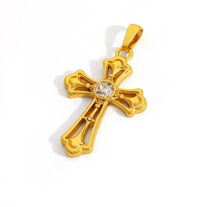 Close-up of golden hollow cross pendant with a central sparkling gemstone setting