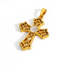 Detailed close-up of a gold hollow-out cross pendant with a large round clear center stone
