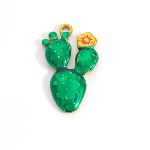 Detail view of green enamel cactus pendant with gold ring and tiny flower accent
