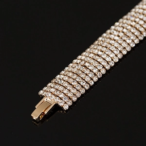 Close-up of golden multi-row rhinestone bracelet with elegant folding clasp detail