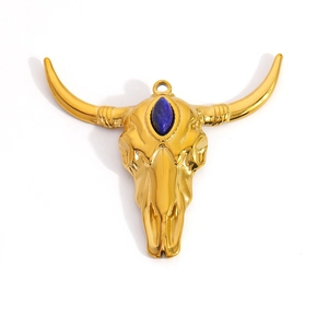 Detailed view of a golden bull skull pendant with a central deep blue gemstone inlay