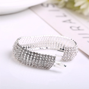Close-up of luxury wide silver bracelet with rows of sparkling white rhinestones