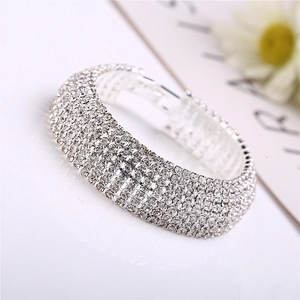Close-up of wide silver rhinestone bracelet featuring multi-row crystal pavé setting