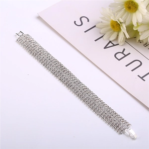 Close-up of wide sparkling rhinestone tennis bracelet with elegant silver plating