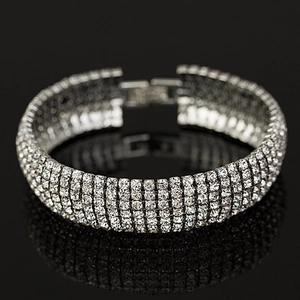 Macro view of five-row luxury rhinestone bracelet with silver finish and mirror reflection