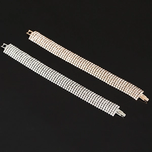 Sparkling multi-row rhinestone bracelet in silver and rose gold finishes on black background
