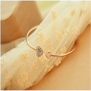 Golden open heart bangle with white rhinestones and pink heart on lace background