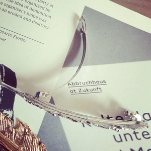Detailed view of silver feather hair clip with metal spring clasp and engraved texture