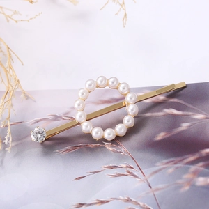 Elegant gold butterfly hair clip with white pearls and sparkling rhinestone accent