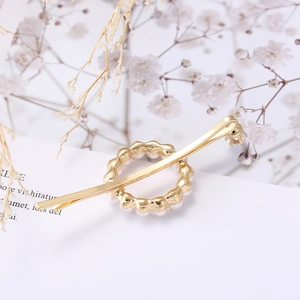 Elegant gold butterfly hair clip with white pearls and zircon accents on aesthetic background