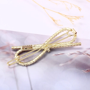 Barrette à cheveux dorée élégante avec strass et design de nœud infini minimaliste