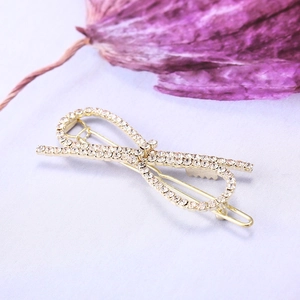 Barrette à cheveux élégante en forme de nœud doré avec strass sur fond violet