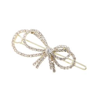 Elegante pinza para el pelo con lazo plateado y brillantes con base de metal dorado
