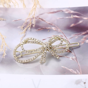 Elegante pinza para el cabello con lazo de diamantes de imitación y base de aleación oro