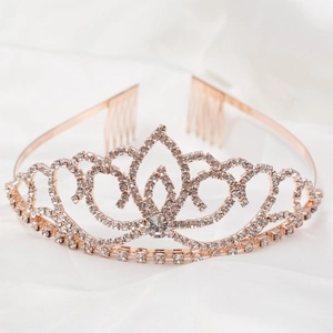 Detailed close-up of rose gold rhinestone crown showing side combs and heart design