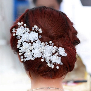 Elegant bridal hair pin with white fabric flowers, pearls and crystals for wedding hairstyles