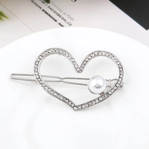 Elegant heart-shaped hair clip with sparkling crystals and a white pearl on a silver base