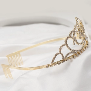 Detailed macro view of the sparkling crystal rhinestones and golden crown metal frame