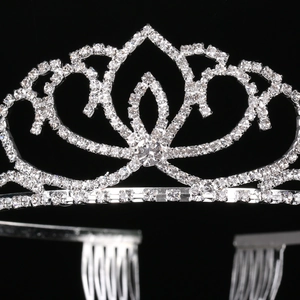 Silver bridal crown with clear rhinestones and petal patterns on a black background