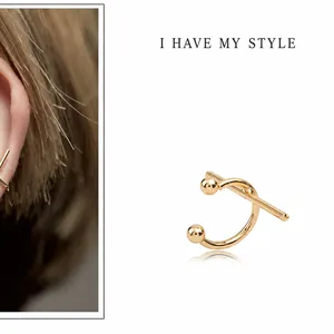 Minimalist gold C-shaped cross ear cuff with polished finish for non-pierced ears