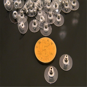 Bulk transparent earring backs with silver metal pads shown next to a coin for scale