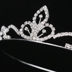 Close-up of silver-plated tiara featuring sparkling rhinestones and hollow leaf patterns