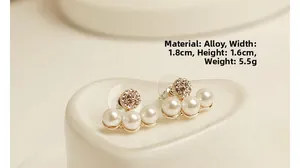 Detail view of gold-plated alloy earrings with three pearls and crystal pavé ball accents
