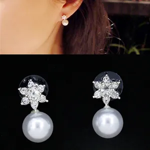 Elegant silver snowflake stud earrings with sparkling rhinestones and white pearls