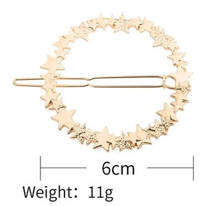 Detail view showing 6cm gold star alloy hair clip dimensions and 11g weight information