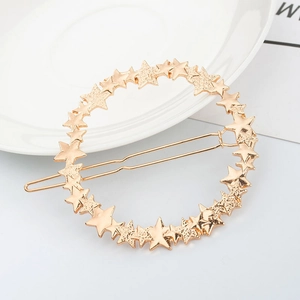 Detail showing creative gold star-shaped circular hair clip with high-quality metal finish
