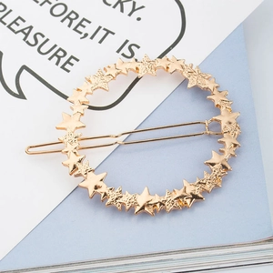 Elegant gold hollow star circle hair clip with matte finish on a minimalist background