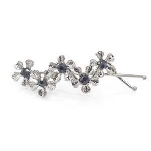 Vintage silver flower hair clip with deep blue crystals and hammered metal texture