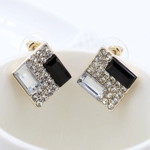 Elegant gold square stud earrings with black and white crystals in a geometric collage design