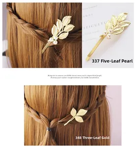 Vue détaillée des pinces à cheveux feuilles dorées avec perles et finition en alliage