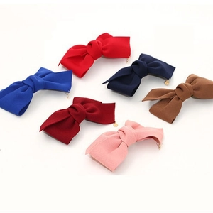 Barrettes à cheveux nœud en tissu en six couleurs avec pendentifs dorés sur fond blanc