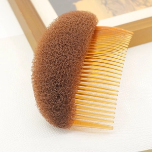 Brown hair volume padding tool with amber plastic comb for elegant hairstyles
